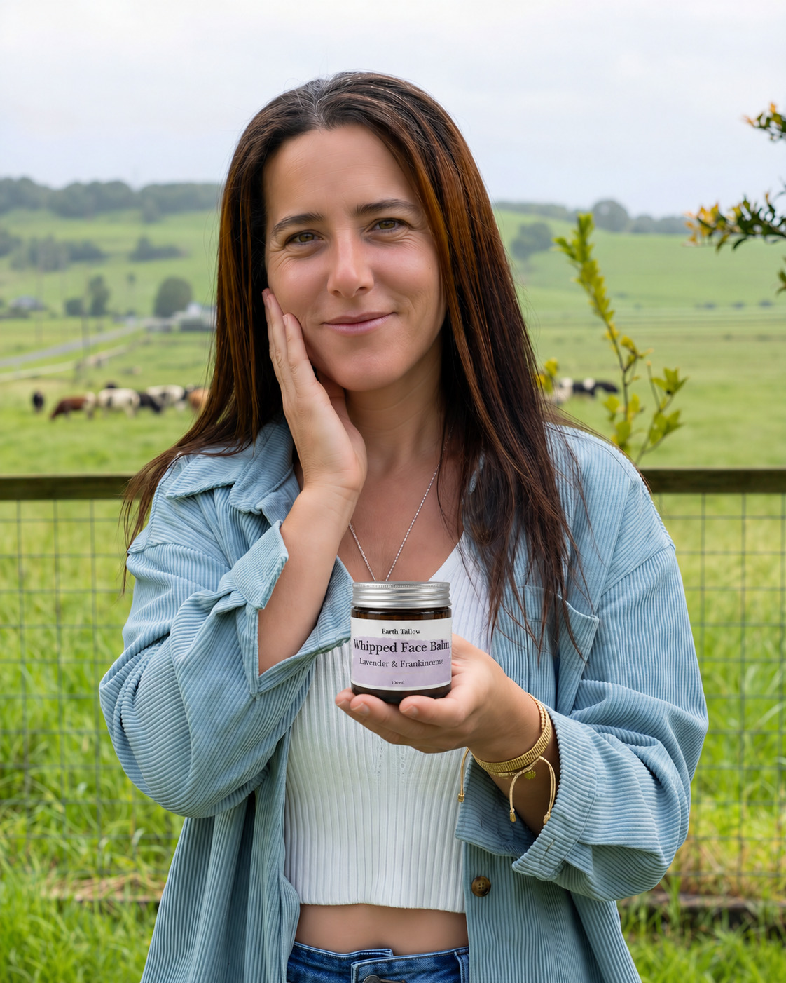 Nashla, founder of Earth Tallow, holding Whipped Face Balm on the farm
